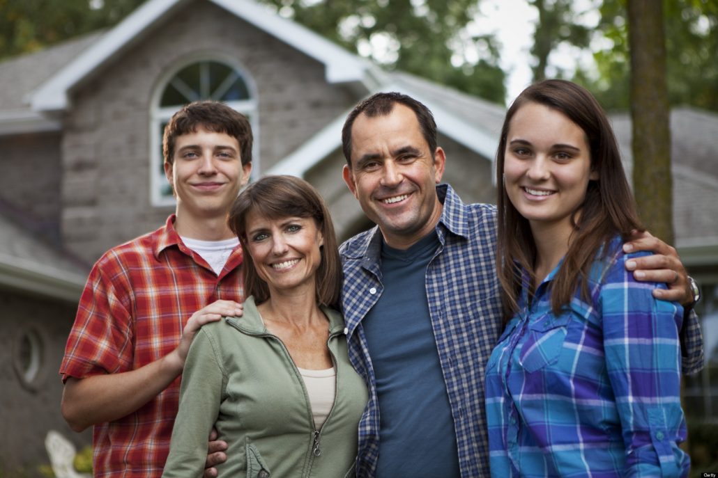 Family in front of suburban home - Cura Living